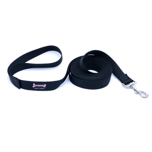 Black nylon dog leash coiled on a white background, featuring a silver metal clasp