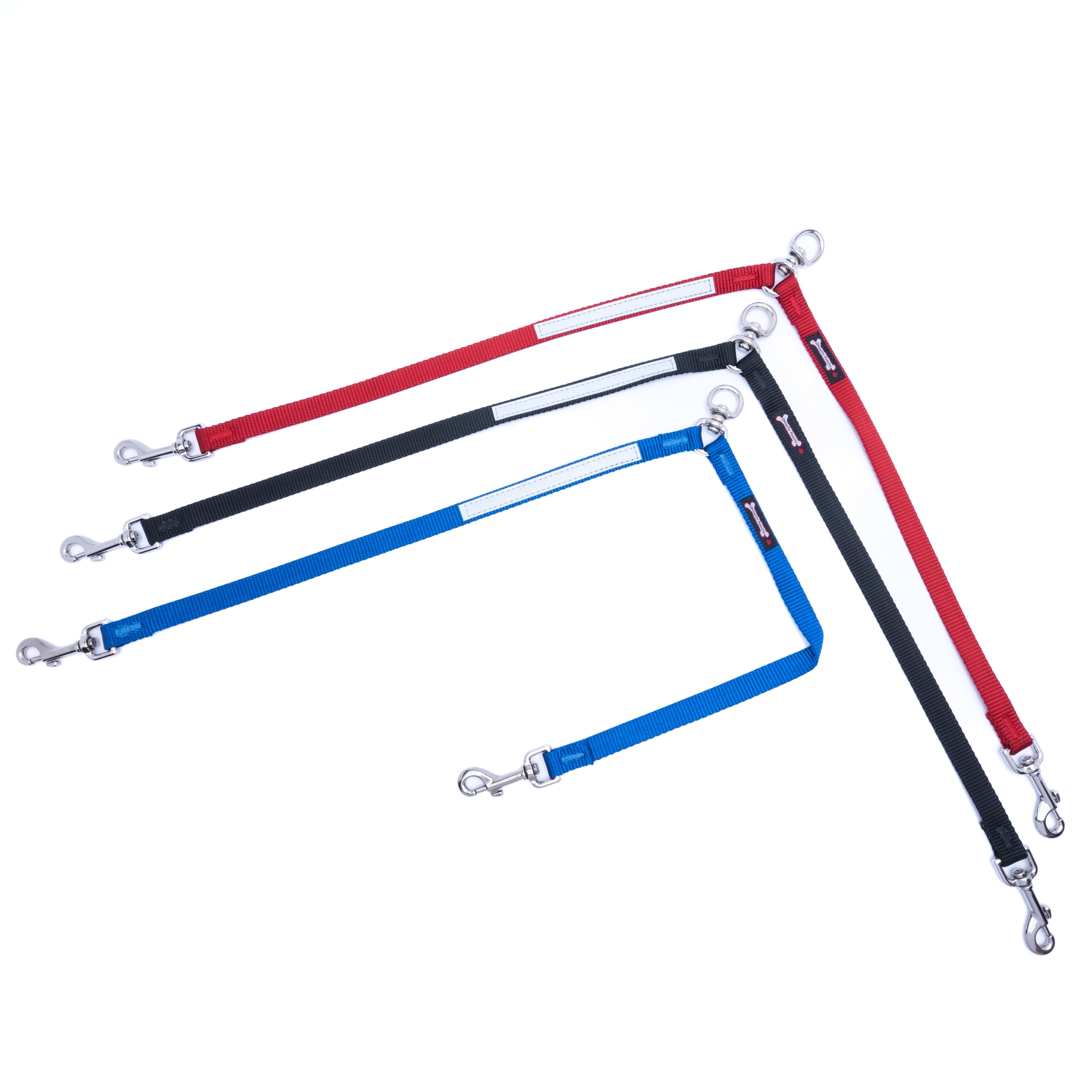 Three dog leashes in red, black, and blue, each featuring a reflective white stripe and silver metal hardware, arranged on a plain white background.