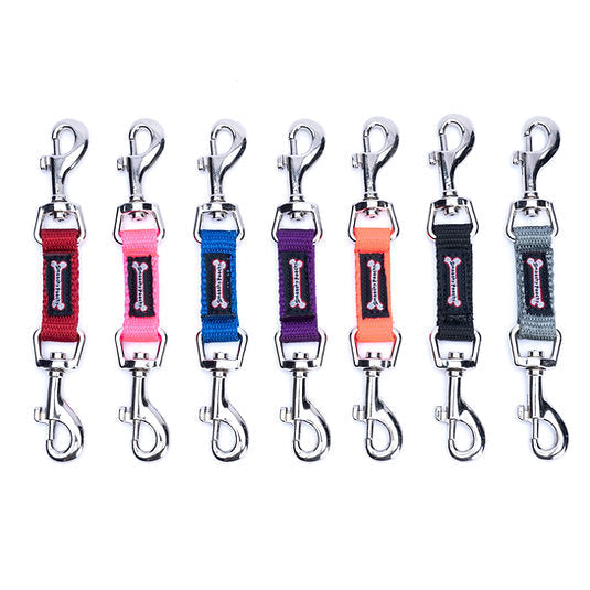 Seven fabric Smoochy Poochy Safety Tabs in various colors with metal clips on both ends, arranged in a row.